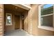 Charming front entry with decorative wreath, stone accents, and covered porch at 23871 N 167Th Ln, Surprise, AZ 85387
