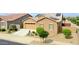 Beautiful home with a well-manicured lawn, desert landscaping, and a convenient two-car garage at 23871 N 167Th Ln, Surprise, AZ 85387