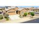 Inviting home with a well-maintained lawn, mature landscaping, and a two-car garage at 23871 N 167Th Ln, Surprise, AZ 85387
