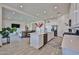 Open-concept kitchen featuring white cabinets, a large island, and seamless flow to the living area at 23871 N 167Th Ln, Surprise, AZ 85387