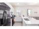 Bright kitchen with stainless steel appliances, breakfast bar, and an open layout connected to the living space at 23871 N 167Th Ln, Surprise, AZ 85387