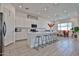 Bright kitchen features white cabinetry, stainless appliances, quartz counters, and an island with seating at 23871 N 167Th Ln, Surprise, AZ 85387