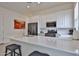 Bright kitchen features white cabinetry, stainless appliances, quartz countertops and a convenient breakfast bar with seating at 23871 N 167Th Ln, Surprise, AZ 85387