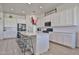 Modern kitchen with white cabinetry, large island, stainless steel appliances, and ample counter space at 23871 N 167Th Ln, Surprise, AZ 85387