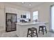 Modern white kitchen with stainless steel appliances, breakfast bar, and sleek design at 23871 N 167Th Ln, Surprise, AZ 85387