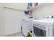 Bright laundry room featuring white washer and dryer, plus shelving for easy storage at 23871 N 167Th Ln, Surprise, AZ 85387