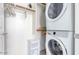 Convenient laundry room with stackable washer and dryer, ample storage, and functional layout at 23871 N 167Th Ln, Surprise, AZ 85387