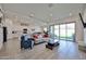 Bright and open living space with tile floors, modern decor, and sliding glass doors to the backyard at 23871 N 167Th Ln, Surprise, AZ 85387