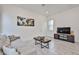 Bright living room featuring a comfortable gray sofa, modern tile flooring and contemporary decor at 23871 N 167Th Ln, Surprise, AZ 85387