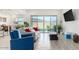 Bright living room featuring a sliding glass door, recessed lighting, and a combination of tile and hardwood floors at 23871 N 167Th Ln, Surprise, AZ 85387