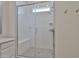 Modern bathroom shower with glass enclosure, bench seat, and horizontal white subway tile at 23871 N 167Th Ln, Surprise, AZ 85387