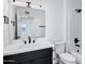 Bathroom features dark vanity, a large mirror and combination tub shower at 250 E Barbarita Ave, Gilbert, AZ 85234
