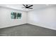 Bright bedroom features a modern ceiling fan, neutral carpet, and a large window at 250 E Barbarita Ave, Gilbert, AZ 85234