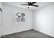 Neutral bedroom features a ceiling fan, closet, window and plush gray carpet at 250 E Barbarita Ave, Gilbert, AZ 85234