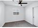 A neutral bedroom has a ceiling fan, a window and plush gray carpet at 250 E Barbarita Ave, Gilbert, AZ 85234
