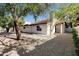Exterior view of the home showcases beautiful landscaping and a charming design at 250 E Barbarita Ave, Gilbert, AZ 85234