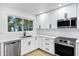 Kitchen features stainless appliances, quartz countertops, white cabinets and sink with window at 250 E Barbarita Ave, Gilbert, AZ 85234