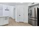 Bright kitchen area with stainless refrigerator, quartz countertops and an adjacent room at 250 E Barbarita Ave, Gilbert, AZ 85234