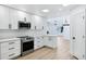 Bright updated kitchen features stainless appliances, white cabinets and quartz countertops at 250 E Barbarita Ave, Gilbert, AZ 85234