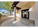 Covered patio features dark-framed doors, providing a relaxing outdoor space at 250 E Barbarita Ave, Gilbert, AZ 85234