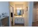 Well-lit bathroom featuring a vanity with a sink, mirror, and neutral tones at 25202 N 142Nd Dr, Surprise, AZ 85387