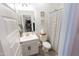Bright bathroom featuring a vanity with a sink, toilet, and a shower with a stylish striped curtain at 25202 N 142Nd Dr, Surprise, AZ 85387