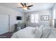 Inviting bedroom with plush bedding, ceiling fan, and a window for natural light at 25202 N 142Nd Dr, Surprise, AZ 85387