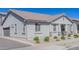 Well-maintained exterior elevation displaying neutral stucco and decorative stone accents at 25202 N 142Nd Dr, Surprise, AZ 85387