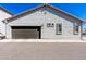 Spacious two-car garage with a modern door and convenient access at 25202 N 142Nd Dr, Surprise, AZ 85387