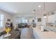 Bright kitchen with open floor plan and large island with quartz countertop at 25202 N 142Nd Dr, Surprise, AZ 85387
