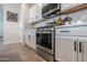 Modern kitchen with stainless steel stove, white cabinets, and tile backsplash at 25202 N 142Nd Dr, Surprise, AZ 85387