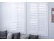 Close-up of plantation shutters and gray sectional sofa in the living room at 25202 N 142Nd Dr, Surprise, AZ 85387
