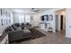 Comfortable living room with gray sectional, plantation shutters, and wood-look tile at 25202 N 142Nd Dr, Surprise, AZ 85387