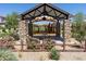 Community playground with shaded picnic benches, lush landscaping, and recreational space at 25202 N 142Nd Dr, Surprise, AZ 85387