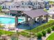 Resort-style pool and covered ramada with stone pillars and outdoor seating create a perfect community gathering spot at 25202 N 142Nd Dr, Surprise, AZ 85387