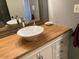 Bathroom vanity featuring a bowl sink and wood countertop at 2602 W Berridge Ln # C102, Phoenix, AZ 85017