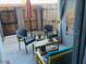 Enclosed patio area with comfortable seating and a wooden privacy fence at 2602 W Berridge Ln # C102, Phoenix, AZ 85017
