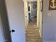 The house hallway is shown with a door on the left and a view of the living room ahead at 2602 W Berridge Ln # C102, Phoenix, AZ 85017