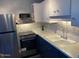 Well-lit kitchen featuring a stainless steel refrigerator and modern countertops and appliances at 2602 W Berridge Ln # C102, Phoenix, AZ 85017