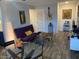 Cozy living area featuring a comfortable futon sofa, wooden coffee table, and guitar, with a cozy vibe at 2602 W Berridge Ln # C102, Phoenix, AZ 85017