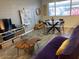 Open living area with comfortable purple sofa, unique wooden coffee table, and adjacent dining space, creating a cozy vibe at 2602 W Berridge Ln # C102, Phoenix, AZ 85017
