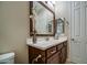 Comfortable bathroom features a white countertop, wood cabinets, tiled floor, and stylish mirrors and accents at 269 E Horseshoe Dr, Chandler, AZ 85249