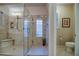 An elegant bathroom featuring a spacious glass shower, natural light and travertine tile at 269 E Horseshoe Dr, Chandler, AZ 85249