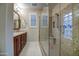 Elegant bathroom boasting dual sinks, granite counters, and a walk-in shower with glass enclosure at 269 E Horseshoe Dr, Chandler, AZ 85249