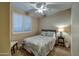 Cozy bedroom featuring neutral colors, a ceiling fan, and shuttered window coverings at 269 E Horseshoe Dr, Chandler, AZ 85249