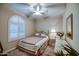 Charming bedroom with an arched window, a ceiling fan, and ample natural light at 269 E Horseshoe Dr, Chandler, AZ 85249
