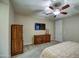 Spacious bedroom boasts matching wood dressers, ceiling fan, and plush carpeting for ultimate comfort at 269 E Horseshoe Dr, Chandler, AZ 85249
