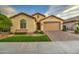 Inviting home with synthetic lawn, mature landscaping, paver driveway, a two car garage and a tile roof at 269 E Horseshoe Dr, Chandler, AZ 85249