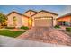 Beautiful single story home with neutral stucco, decorative tile roof and a paver driveway and walkway at 269 E Horseshoe Dr, Chandler, AZ 85249