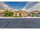 Single story home with a two car garage, paver driveway, synthetic lawn and desert landscaping at 269 E Horseshoe Dr, Chandler, AZ 85249